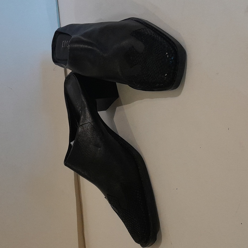 This is a leather black mule shoe.